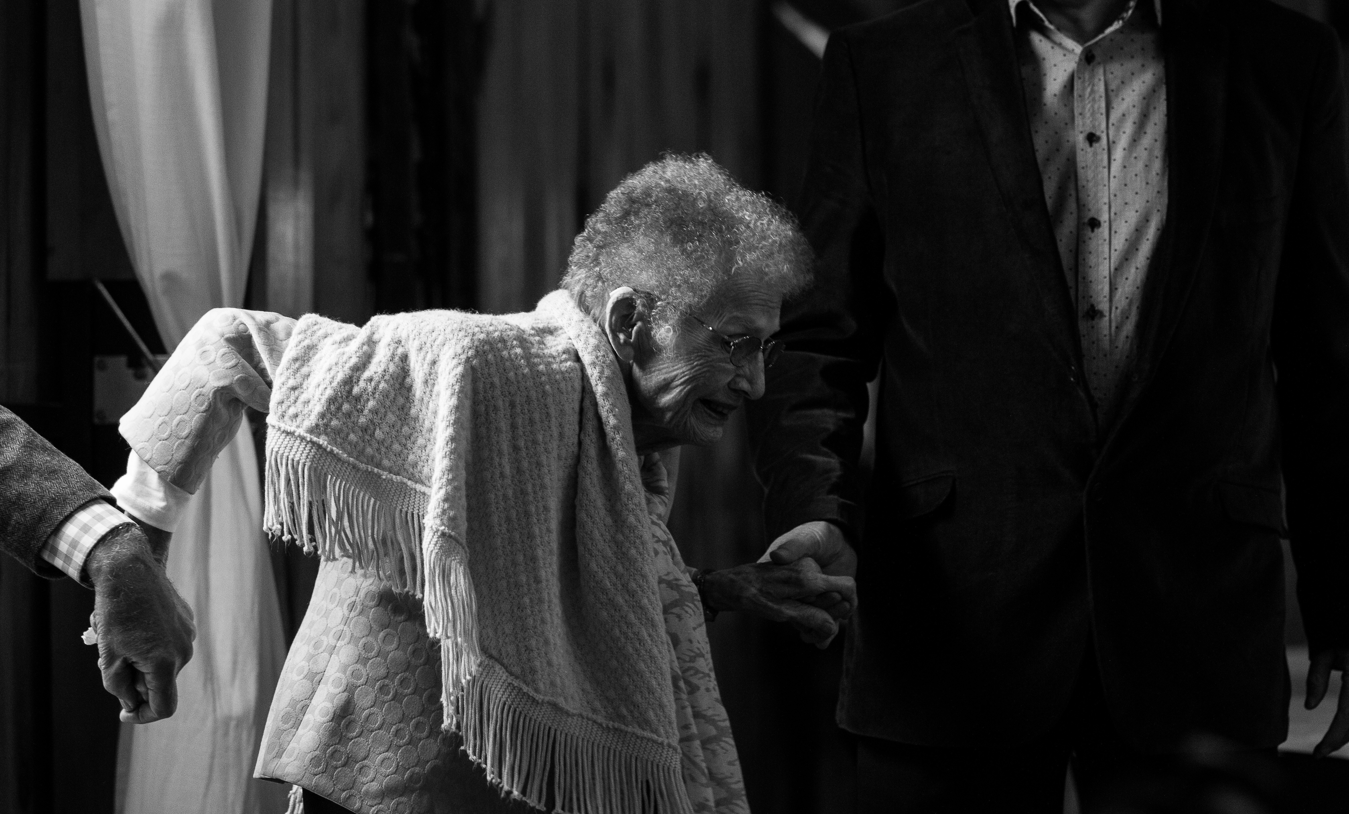 elderly woman holding hands