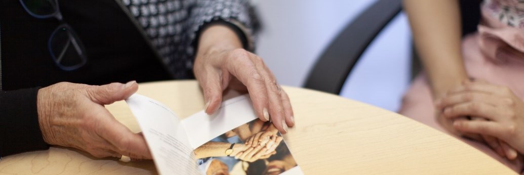 Hands holding a pamphlet