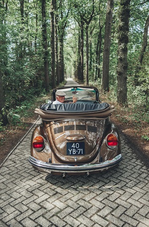 Elderly man in old car